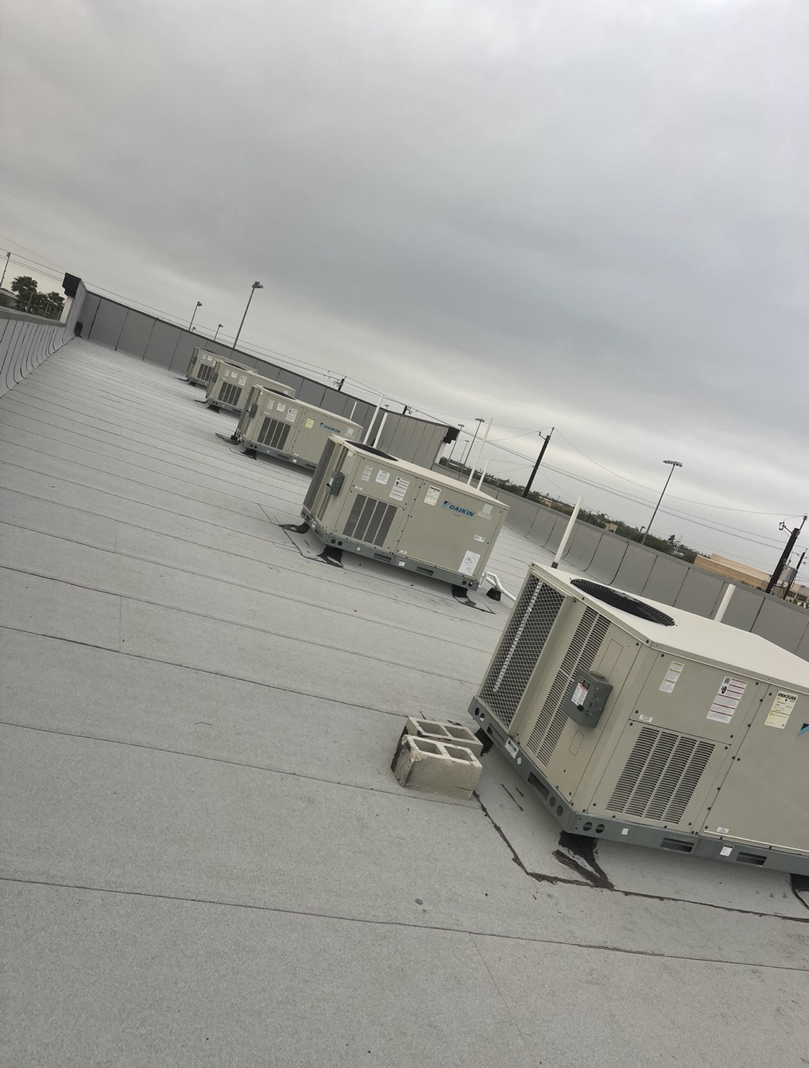 Multiple Daikin rooftop HVAC units on a commercial building